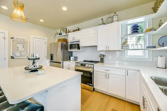 a kitchen with a sink appliances and cabinets