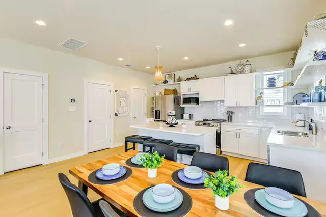a kitchen with a table and chairs in it