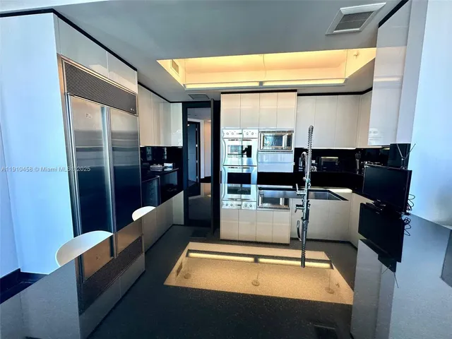 a kitchen with granite countertop a stove a sink and a microwave