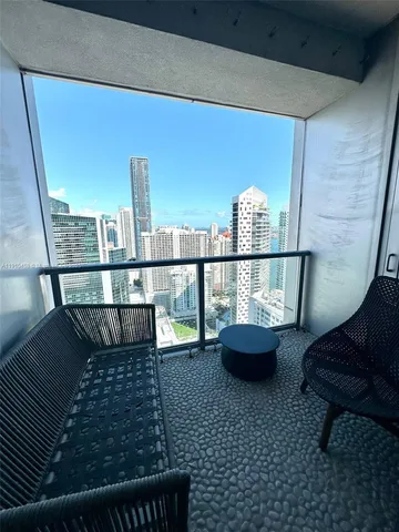 a view of a hallway to a livingroom with furniture