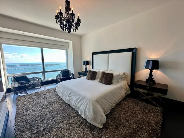 a bed room with a bed and a large window