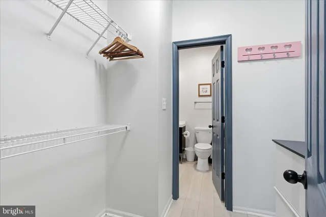 a bathroom with a sink a toilet a mirror and shower