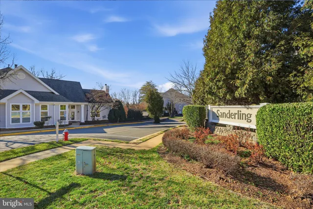 a view of a terrace with a barbeque and wooden fence