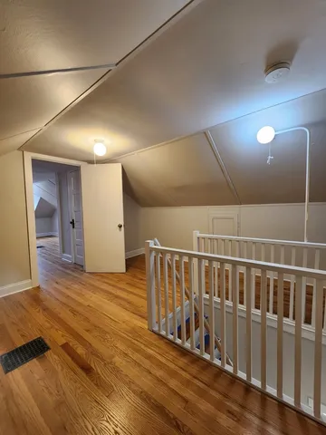 a view of hallway with wooden floor