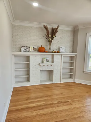 a view of kitchen cabinets and wooden floor