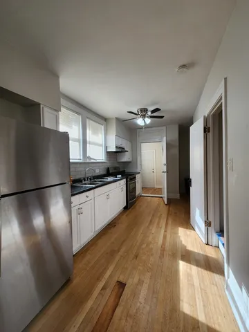 a kitchen with stainless steel appliances a refrigerator and a stove top oven