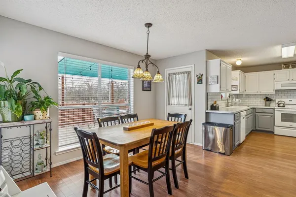 a dining room with furniture window and wooden floor