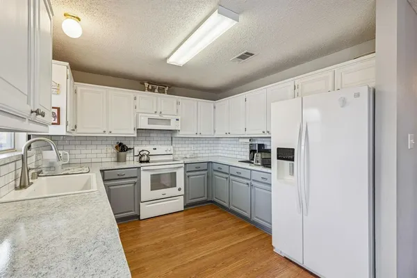 a kitchen with cabinets stainless steel appliances and a counter space