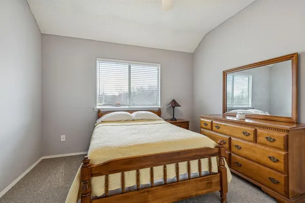 a bedroom with a bed and a dresser