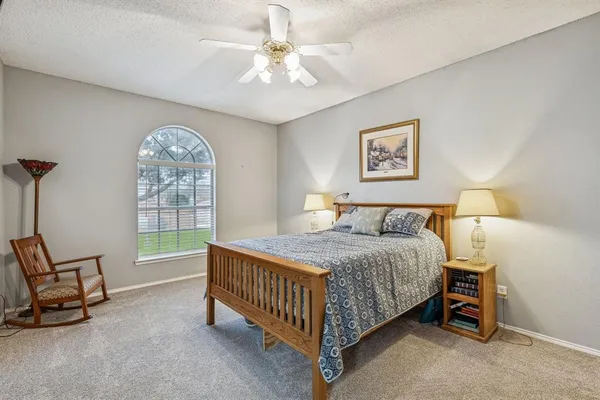 a bedroom with a bed a chair and bed