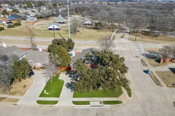 an aerial view of a house with a yard and lake view