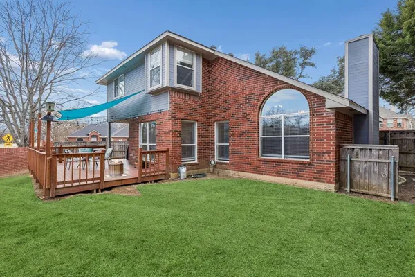 a front view of a house with a yard table and chairs