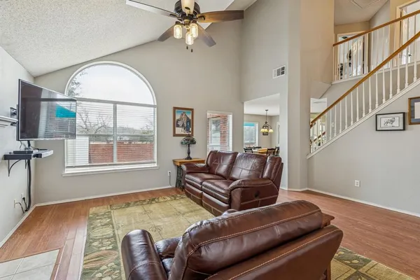 a living room with furniture and a wooden floor