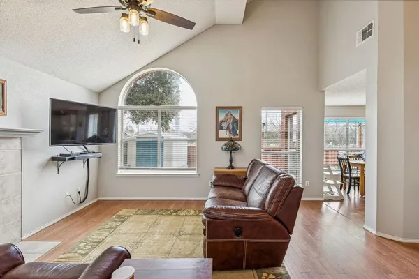 a living room with furniture a flat screen tv and a large window