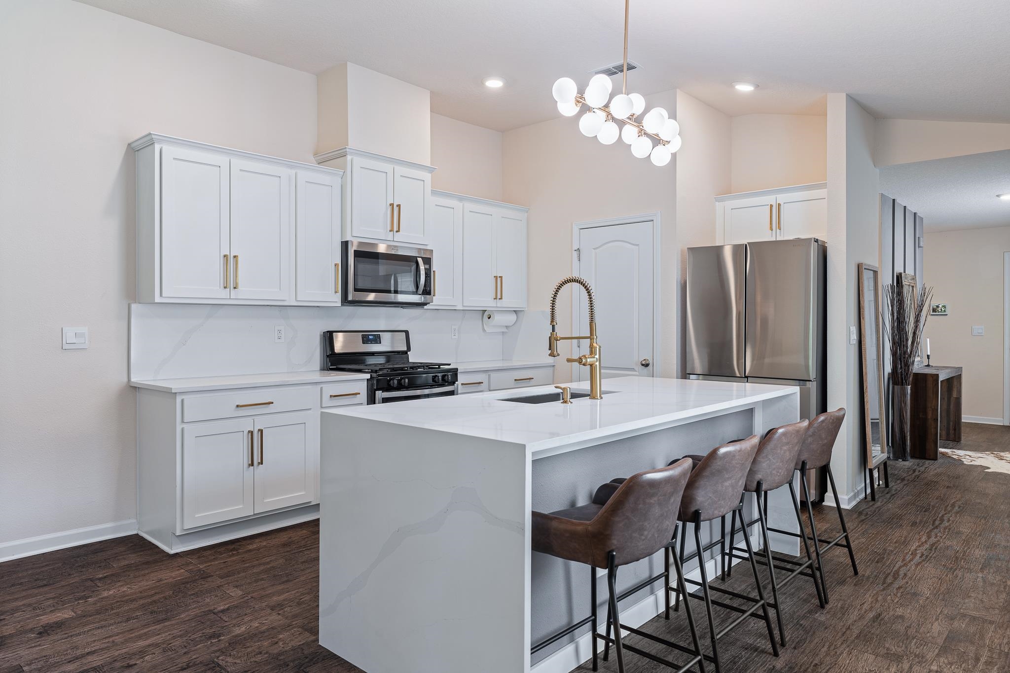 147 Logrono Court St. Augustine, FL 32084 - Photo 8 of 50 a kitchen with stainless steel appliances a table chairs refrigerator and microwave