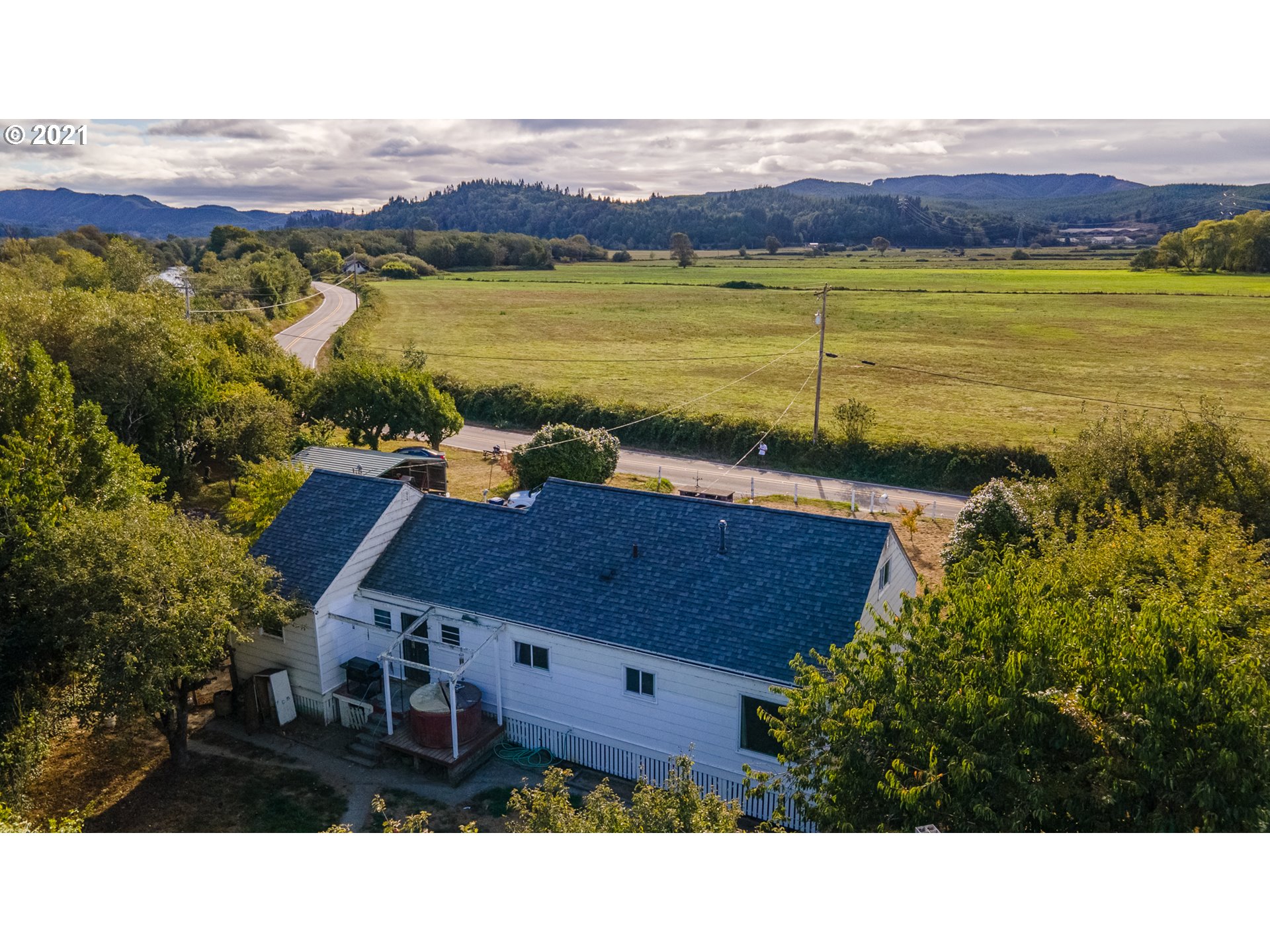 55561 Fishtrap Road Coquille, OR 97423 - Photo 2 of 31 a view of a terrace with a garden and trees