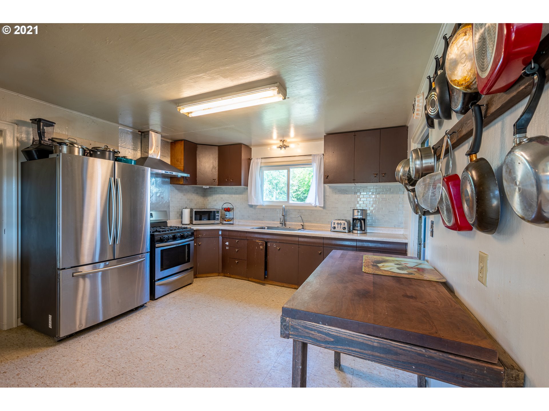 55561 Fishtrap Road Coquille, OR 97423 - Photo 23 of 31 a kitchen with stainless steel appliances granite countertop a refrigerator and a sink