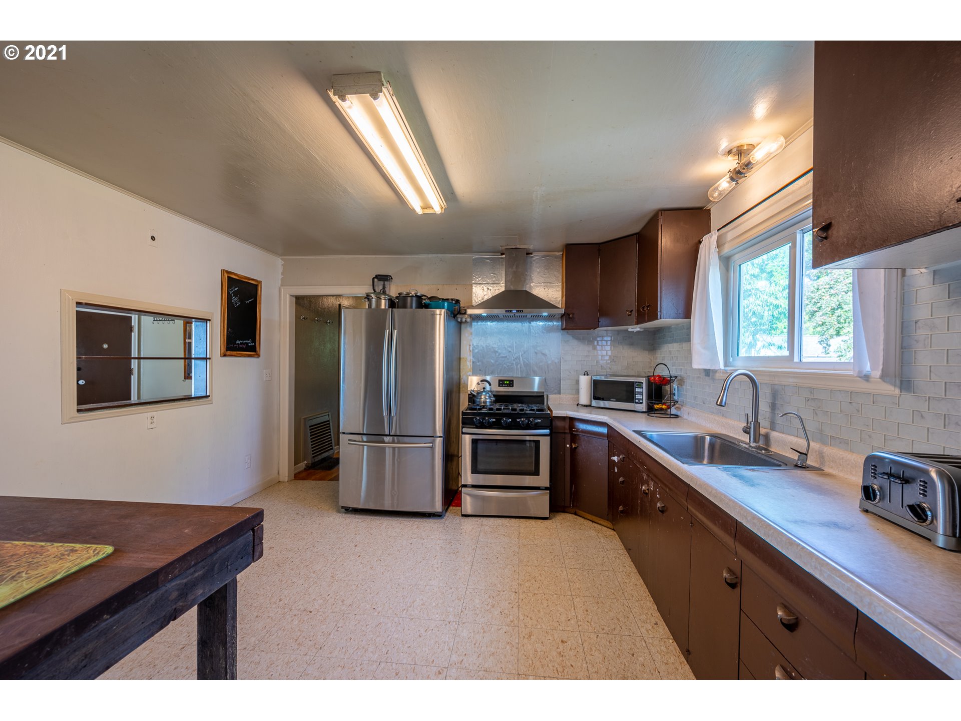55561 Fishtrap Road Coquille, OR 97423 - Photo 24 of 31 a kitchen with refrigerator and window