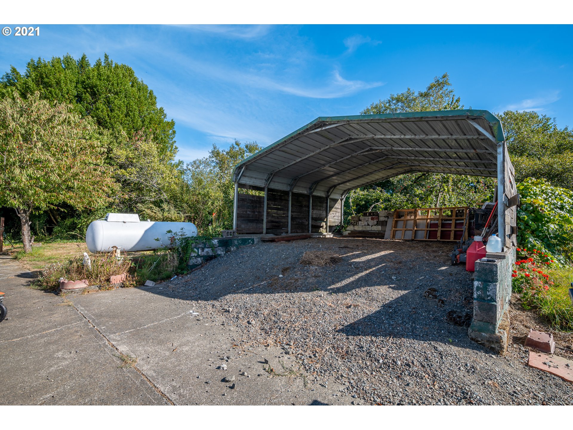 55561 Fishtrap Road Coquille, OR 97423 - Photo 6 of 31 a view of a patio with a table and chairs under an umbrella
