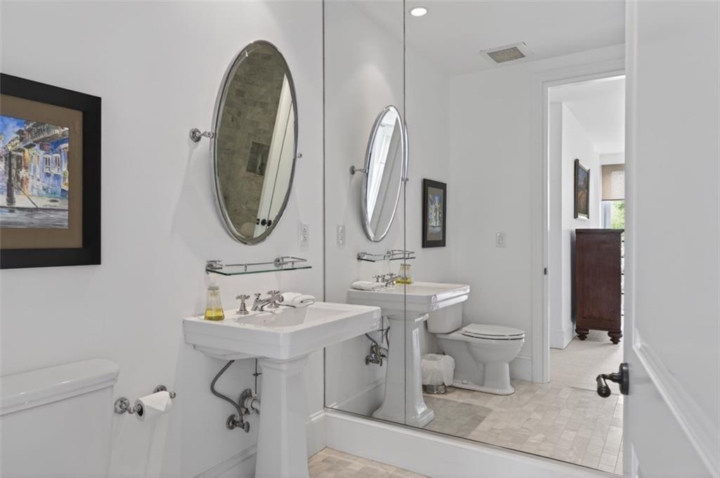 2288 Peachtree Road Northwest, Unit 4 Atlanta, GA 30309 - Photo 36 of 50 a bathroom with a toilet sink and mirror