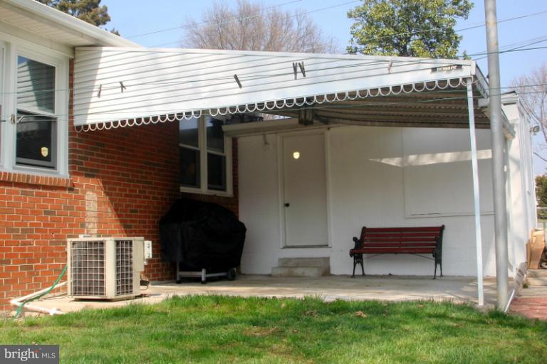 8803 Riggs Road Hyattsville, MD 20783 - Photo 11 of 24 a backyard of a house with barbeque oven and a yard
