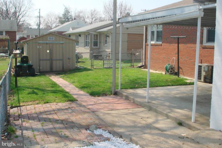 8803 Riggs Road Hyattsville, MD 20783 - Photo 14 of 24 a view of a house with a yard and pathway
