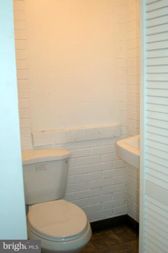 8803 Riggs Road Hyattsville, MD 20783 - Photo 16 of 24 a bathroom with a toilet and a shower