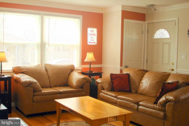 8803 Riggs Road Hyattsville, MD 20783 - Photo 3 of 24 a living room with furniture and a large window