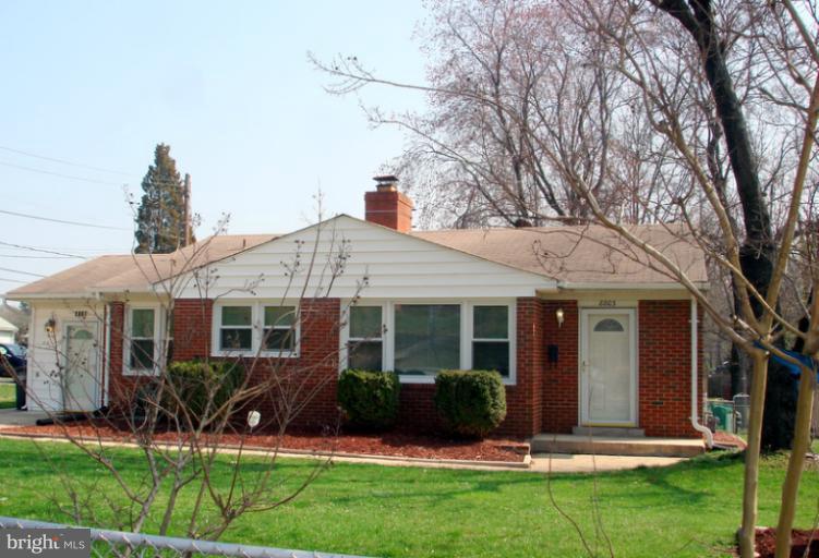 8803 Riggs Road Hyattsville, MD 20783 - Photo 22 of 24 a view of a house with a yard and plants