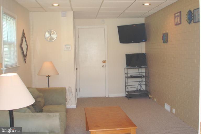 8803 Riggs Road Hyattsville, MD 20783 - Photo 6 of 24 a living room with furniture and a lamp