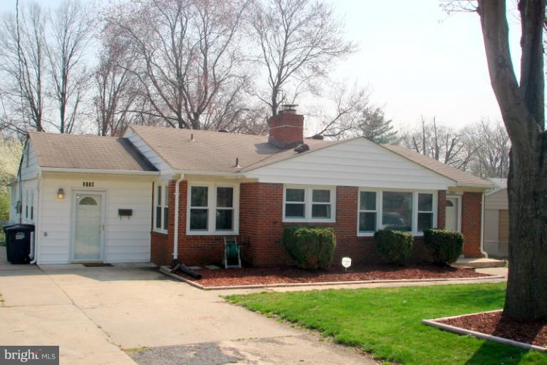 8803 Riggs Road Hyattsville, MD 20783 - Photo 7 of 24 a front view of a house with a yard and potted plants