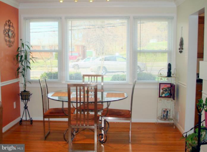 8803 Riggs Road Hyattsville, MD 20783 - Photo 8 of 24 a view of a dining room with furniture window and wooden floor