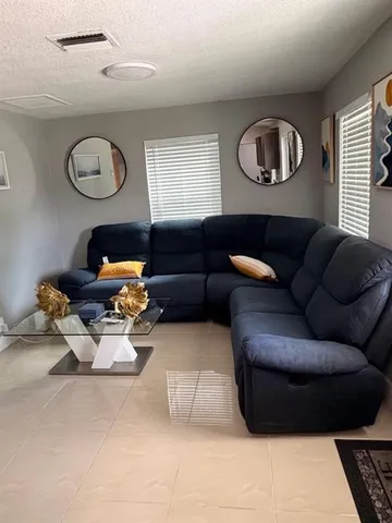 a living room with furniture chess board and a window
