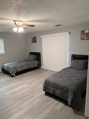 a bedroom with a bed and lamp