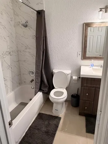 a bathroom with a toilet a sink and bathtub
