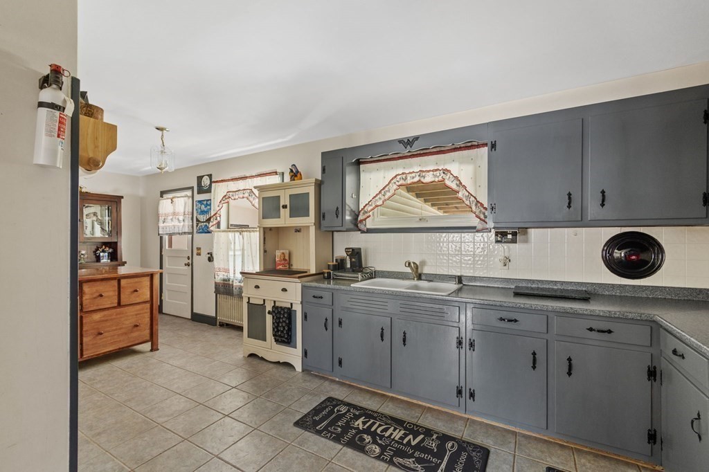 1247 Bay Road Sharon, MA 02067 - Photo 14 of 41 a kitchen with stainless steel appliances a stove sink and cabinets
