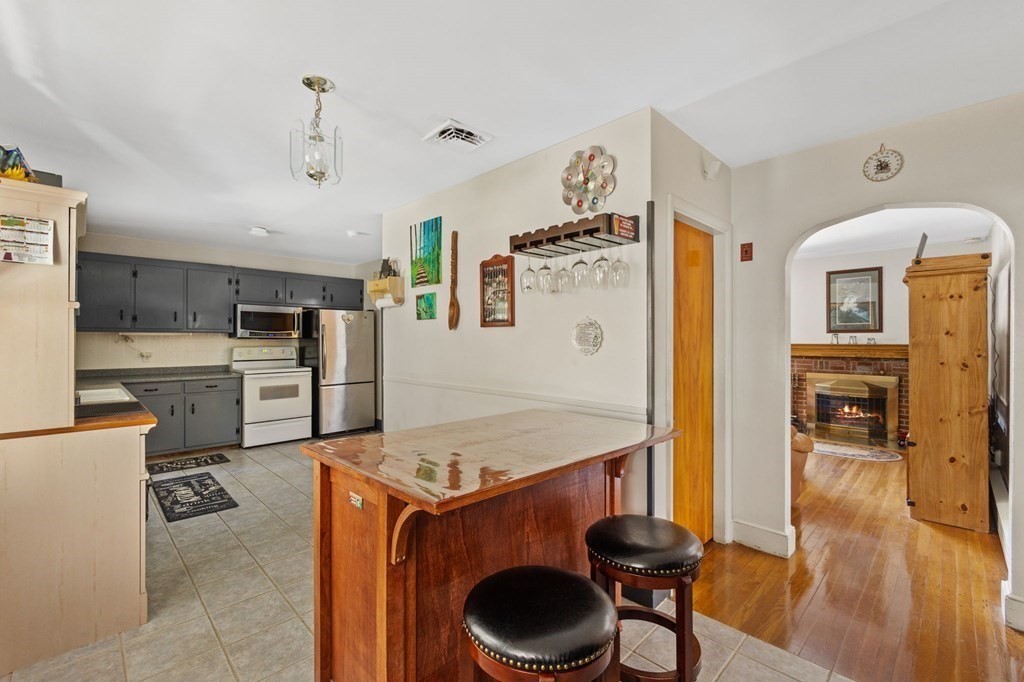 1247 Bay Road Sharon, MA 02067 - Photo 17 of 41 a living room with stainless steel appliances granite countertop furniture and wooden floor