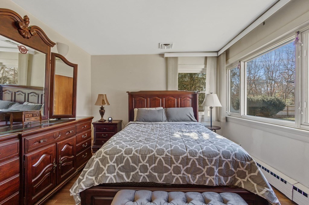 1247 Bay Road Sharon, MA 02067 - Photo 19 of 41 a bedroom with a bed and a dresser with mirror