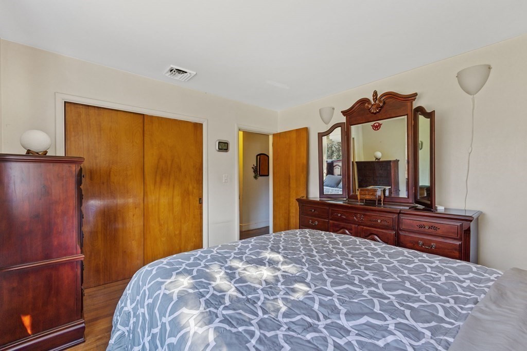 1247 Bay Road Sharon, MA 02067 - Photo 20 of 41 a bedroom with a bed and a dresser with mirror
