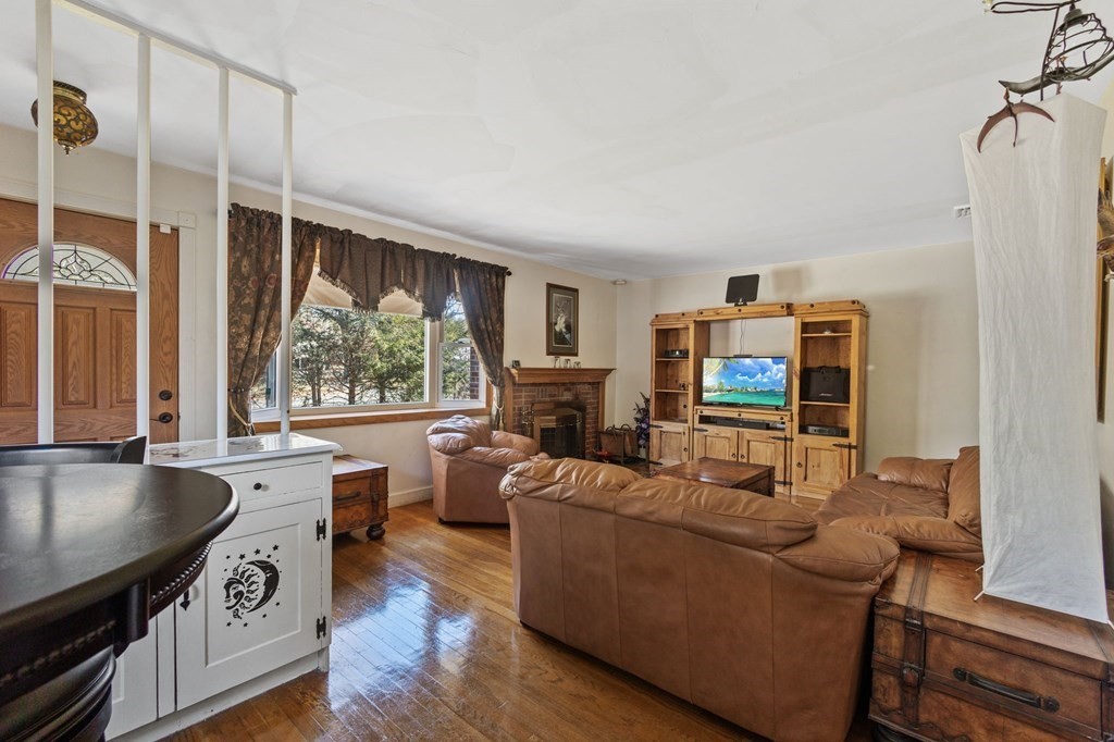 1247 Bay Road Sharon, MA 02067 - Photo 7 of 41 a living room with furniture a flat screen tv and a large window