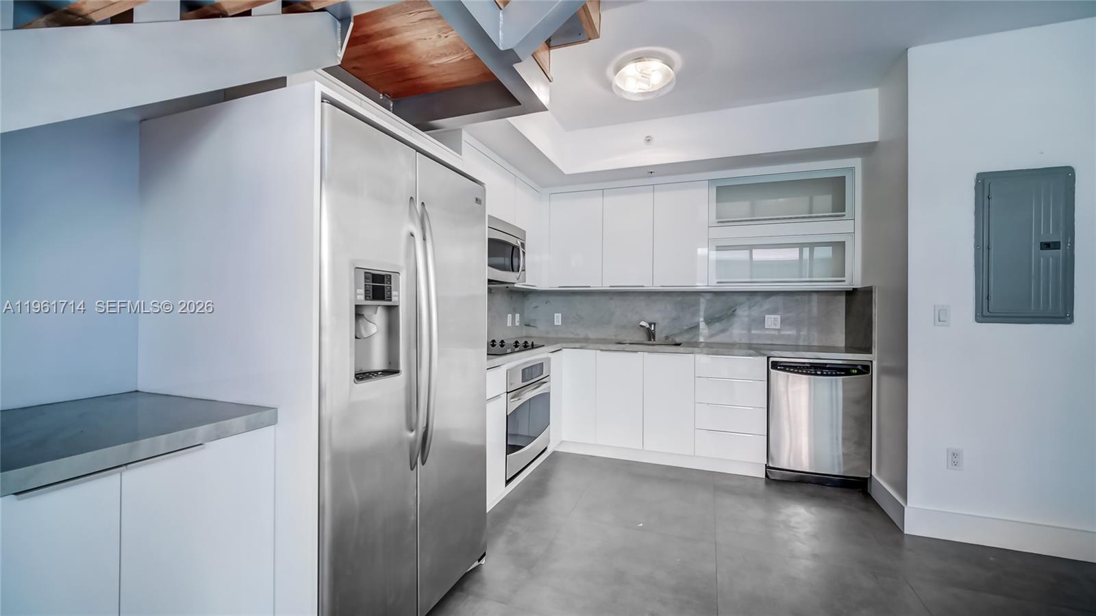 90 Southwest 3rd Street, Unit TH706 Miami, FL 33130 - Photo 12 of 37 a kitchen with a refrigerator and a sink