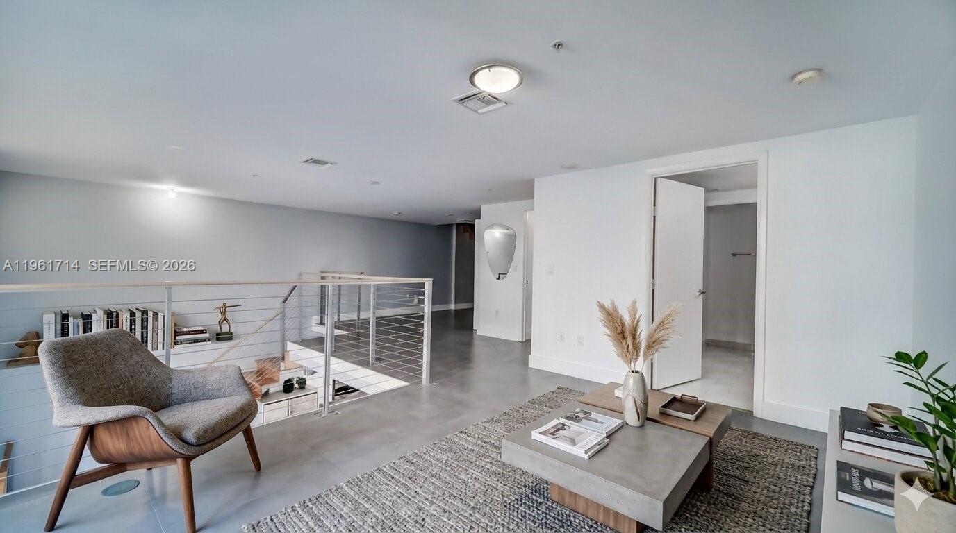 90 Southwest 3rd Street, Unit TH706 Miami, FL 33130 - Photo 21 of 37 a living room with furniture and wooden floor