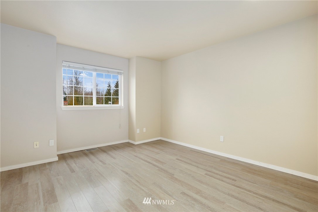 17539 110 Lane Southeast, Unit 20 Renton, WA 98055 - Photo 16 of 25 an empty room with wooden floor and windows