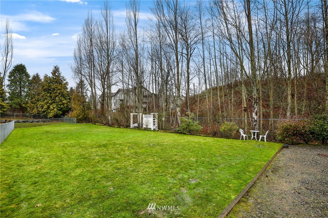 17539 110 Lane Southeast, Unit 20 Renton, WA 98055 - Photo 23 of 25 a garden with trees in front of it