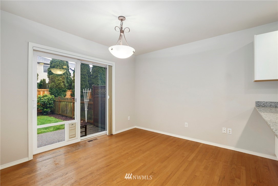 17539 110 Lane Southeast, Unit 20 Renton, WA 98055 - Photo 4 of 25 a view of an empty room with wooden floor and a window