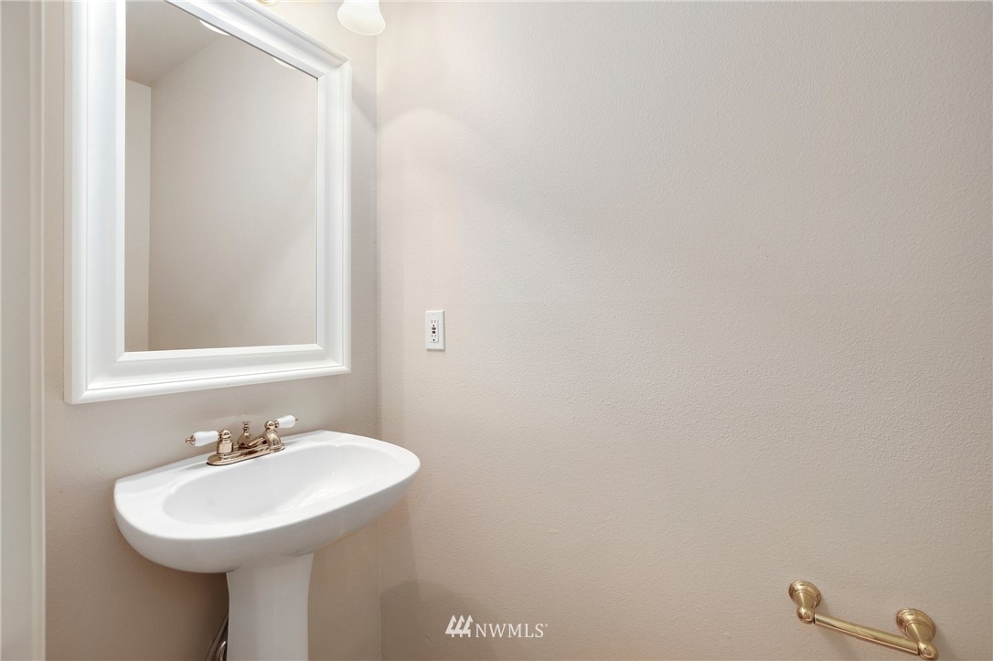 17539 110 Lane Southeast, Unit 20 Renton, WA 98055 - Photo 8 of 25 a bathroom with a sink a mirror and a toilet