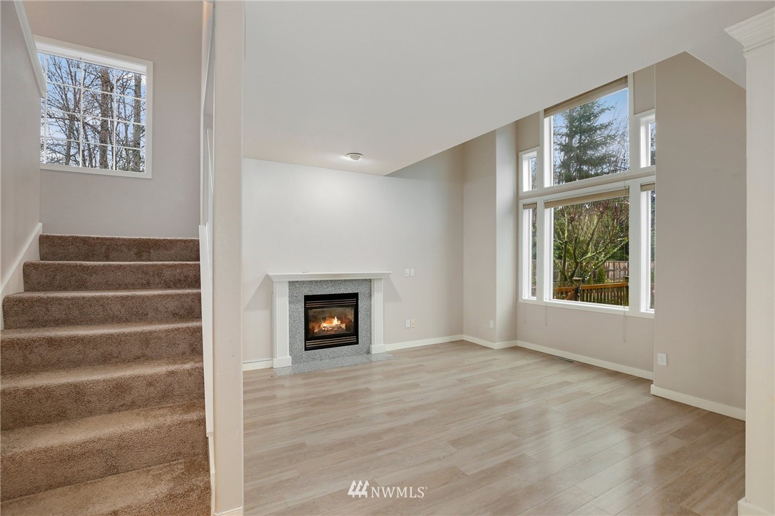 17539 110 Lane Southeast, Unit 20 Renton, WA 98055 - Photo 10 of 25 a view of an empty room with wooden floor and a window