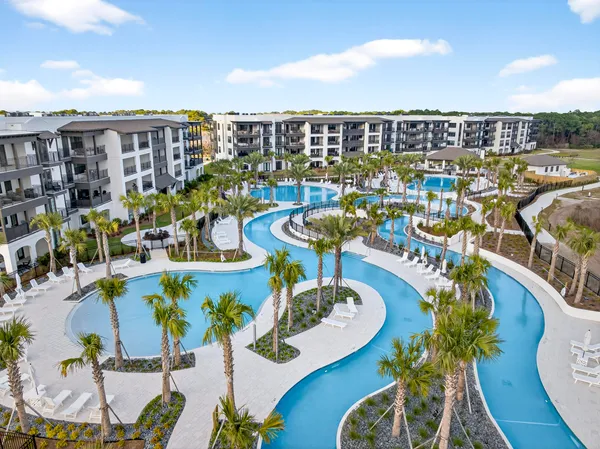 a view of a swimming pool with outdoor seating