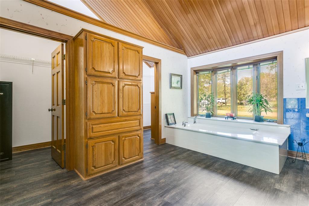 1557 Latigo Hills Road Bartonville, TX 75022 - Photo 20 of 40 Full bath featuring a garden tub, dark wood-style flooring, a vaulted wood ceiling, and ornamental molding