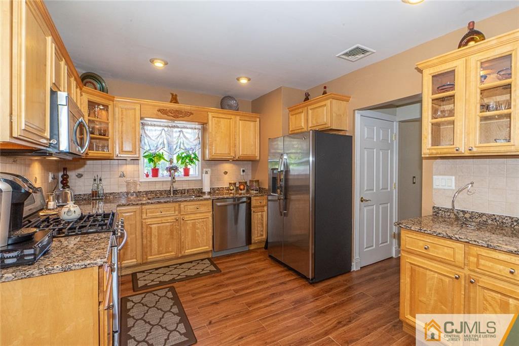 101 Aberdeen Road Aberdeen, NJ 07747 - Photo 14 of 21 a kitchen with stainless steel appliances granite countertop a refrigerator and a stove top oven